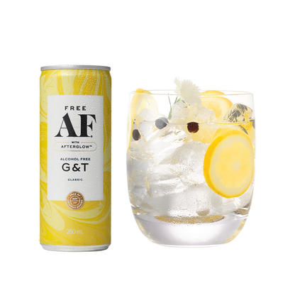 Alcohol-free gin and tonic can with a glass of the drink on a white background
